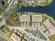 Overhead perspective of townhomes featuring rooftop architecture, parking facilities, and views of the adjacent pond at 2764 Countryside Blvd # 3, Clearwater, FL 33761