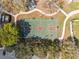 Aerial view of basketball court in a neighborhood park, surrounded by trees and pathways at 2764 Countryside Blvd # 3, Clearwater, FL 33761