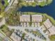 Birds-eye view of community townhomes showing rooftops, parking, and a serene pond, highlighting community layout at 2764 Countryside Blvd # 3, Clearwater, FL 33761