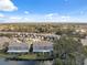 Aerial image of townhomes featuring water views, ample parking, and community layout amidst lush greenery at 2764 Countryside Blvd # 3, Clearwater, FL 33761