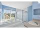 Bright bathroom featuring a large soaking tub, walk-in shower, and vanity at 2764 Countryside Blvd # 3, Clearwater, FL 33761