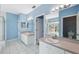 Bright bathroom featuring double sinks, mirrors, and tiled floor with a view of the bath at 2764 Countryside Blvd # 3, Clearwater, FL 33761