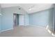 Bright bedroom featuring neutral carpeting, a ceiling fan, and two white interior doors at 2764 Countryside Blvd # 3, Clearwater, FL 33761