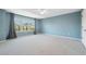 Bright bedroom features large windows and neutral carpet with a ceiling fan at 2764 Countryside Blvd # 3, Clearwater, FL 33761