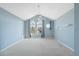 Spacious bedroom with vaulted ceiling, neutral carpet, fan, and abundant natural light from arched windows at 2764 Countryside Blvd # 3, Clearwater, FL 33761