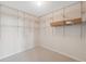 Walk-in closet with adjustable white wire shelving for optimal organization at 2764 Countryside Blvd # 3, Clearwater, FL 33761
