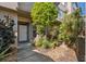 Inviting home entrance with beautiful, lush landscaping and a well-lit doorway with a white door at 2764 Countryside Blvd # 3, Clearwater, FL 33761