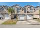 Townhouse exterior showcasing multi-car garages, stucco facades, manicured landscaping and architectural design at 2764 Countryside Blvd # 3, Clearwater, FL 33761
