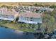 Townhome exterior with screened patio overlooking a calm lake, offering peaceful outdoor living at 2764 Countryside Blvd # 3, Clearwater, FL 33761