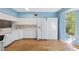 Spacious kitchen featuring white cabinets, modern appliances, hardwood floors, and lots of counter space at 2764 Countryside Blvd # 3, Clearwater, FL 33761