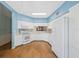 Bright kitchen with white cabinets, white appliances, and tile floors at 2764 Countryside Blvd # 3, Clearwater, FL 33761