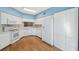 Spacious kitchen with white cabinetry, modern appliances, hardwood floors, and ample counter space at 2764 Countryside Blvd # 3, Clearwater, FL 33761