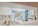 Bright kitchen featuring white cabinets, tile backsplash, and hardwood floors, open to a cozy eating area at 2764 Countryside Blvd # 3, Clearwater, FL 33761