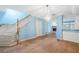 Spacious living area with staircase leading upstairs, complete with tile floors and modern chandelier at 2764 Countryside Blvd # 3, Clearwater, FL 33761