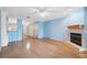 Hardwood floors, fireplace, and light blue wall color scheme in this open-concept design living room at 2764 Countryside Blvd # 3, Clearwater, FL 33761