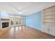 Bright living room with hardwood floors, fireplace, and french doors offering outdoor access and natural light at 2764 Countryside Blvd # 3, Clearwater, FL 33761