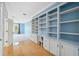 Home office with custom built-in shelving and storage, next to a carpeted living area at 2764 Countryside Blvd # 3, Clearwater, FL 33761