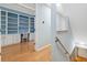 Bright office space with built-in shelving and hardwood floors viewed from the stairwell at 2764 Countryside Blvd # 3, Clearwater, FL 33761