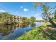 Scenic view of the water with lush landscaping surrounding condo buildings at 2764 Countryside Blvd # 3, Clearwater, FL 33761