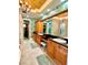 Spacious bathroom with dual vanities, decorative wallpaper, and modern lighting at 2806 Grey Oaks Blvd, Tarpon Springs, FL 34688