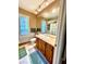 Bathroom featuring a wooden vanity, tiled floors, and shower at 2806 Grey Oaks Blvd, Tarpon Springs, FL 34688