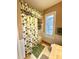 Bathroom featuring a shower with patterned curtain and a window with shutters at 2806 Grey Oaks Blvd, Tarpon Springs, FL 34688