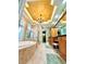 Elegant bathroom showcasing a soaking tub, glass shower, and decorative vanity with dual sinks at 2806 Grey Oaks Blvd, Tarpon Springs, FL 34688
