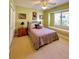 Cozy bedroom featuring a window bench and a comfortable queen-sized bed at 2806 Grey Oaks Blvd, Tarpon Springs, FL 34688