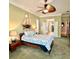 Comfortable bedroom with nautical décor and a glimpse into the ensuite bathroom at 2806 Grey Oaks Blvd, Tarpon Springs, FL 34688