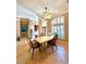 Elegant dining room with large windows, travertine tile flooring, and stylish decor at 2806 Grey Oaks Blvd, Tarpon Springs, FL 34688