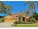 Charming single-story home with a well-manicured front yard, beautiful landscaping, and a two-car garage at 2806 Grey Oaks Blvd, Tarpon Springs, FL 34688