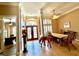 Bright foyer featuring tile flooring, high ceilings, and decorative columns, leading to the dining and office areas at 2806 Grey Oaks Blvd, Tarpon Springs, FL 34688