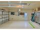 Clean two car garage featuring an epoxy floor, new door and updated fixtures at 2806 Grey Oaks Blvd, Tarpon Springs, FL 34688