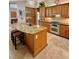 Kitchen island with granite countertop and seating with stainless steel oven at 2806 Grey Oaks Blvd, Tarpon Springs, FL 34688