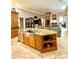 Spacious kitchen island with granite countertops and stainless steel sink at 2806 Grey Oaks Blvd, Tarpon Springs, FL 34688