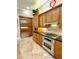 Stainless steel oven and fridge with beautiful wooden kitchen cabinets at 2806 Grey Oaks Blvd, Tarpon Springs, FL 34688