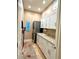 Functional laundry room with white cabinets, modern washer/dryer, and a convenient sink at 2806 Grey Oaks Blvd, Tarpon Springs, FL 34688