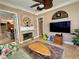 Living room with fireplace, neutral walls, tile floors, ceiling fan and view to the dining room at 2806 Grey Oaks Blvd, Tarpon Springs, FL 34688