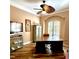 Home office with custom desk, ceiling fan, and natural light from the shuttered windows at 2806 Grey Oaks Blvd, Tarpon Springs, FL 34688