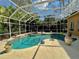 This screened pool and spa area is surrounded by mature landscaping providing privacy at 2806 Grey Oaks Blvd, Tarpon Springs, FL 34688