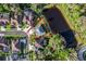 Aerial view of the property highlighting its proximity to a picturesque pond, surrounded by lush greenery at 28752 Falling Leaves Way, Wesley Chapel, FL 33543