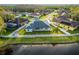 Aerial view of the backyard with a white picket fence and proximity to a tranquil pond at 28752 Falling Leaves Way, Wesley Chapel, FL 33543