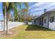 A spacious backyard features a white picket fence, a shed, and lush grass at 28752 Falling Leaves Way, Wesley Chapel, FL 33543