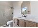 Modern bathroom features clear glass shower with rainfall shower head, vanity with chevron cabinet, and marble countertops at 28752 Falling Leaves Way, Wesley Chapel, FL 33543