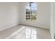 Bright bedroom with a large window, tile flooring, and ample natural light at 28752 Falling Leaves Way, Wesley Chapel, FL 33543