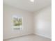 Bright bedroom with a view of the white picket fence and fresh paint at 28752 Falling Leaves Way, Wesley Chapel, FL 33543