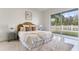 Bright bedroom with a large window, white walls, light-colored carpet, and a comfortable bed at 28752 Falling Leaves Way, Wesley Chapel, FL 33543