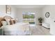 Inviting bedroom features a comfortable bed, natural light, and a view of the backyard at 28752 Falling Leaves Way, Wesley Chapel, FL 33543