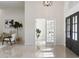 Bright foyer with high ceilings, tiled floors, and elegant double doors at 28752 Falling Leaves Way, Wesley Chapel, FL 33543