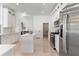 Modern white kitchen featuring stainless steel appliances and a center island at 28752 Falling Leaves Way, Wesley Chapel, FL 33543